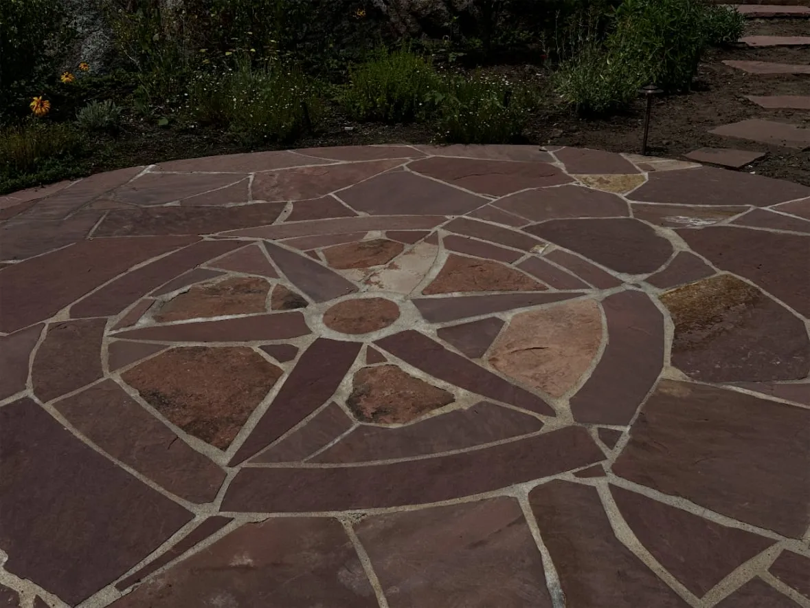 Circular flagstone patio with a compass-pattern stone design