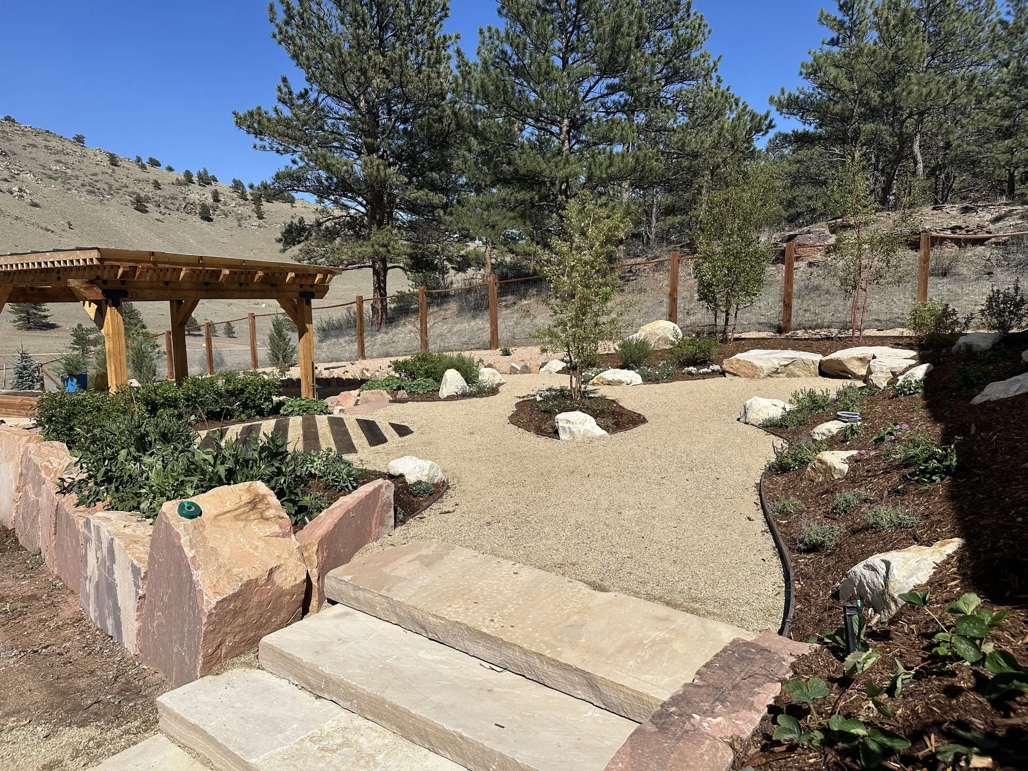 Xeriscape garden with a pergola and mountain views