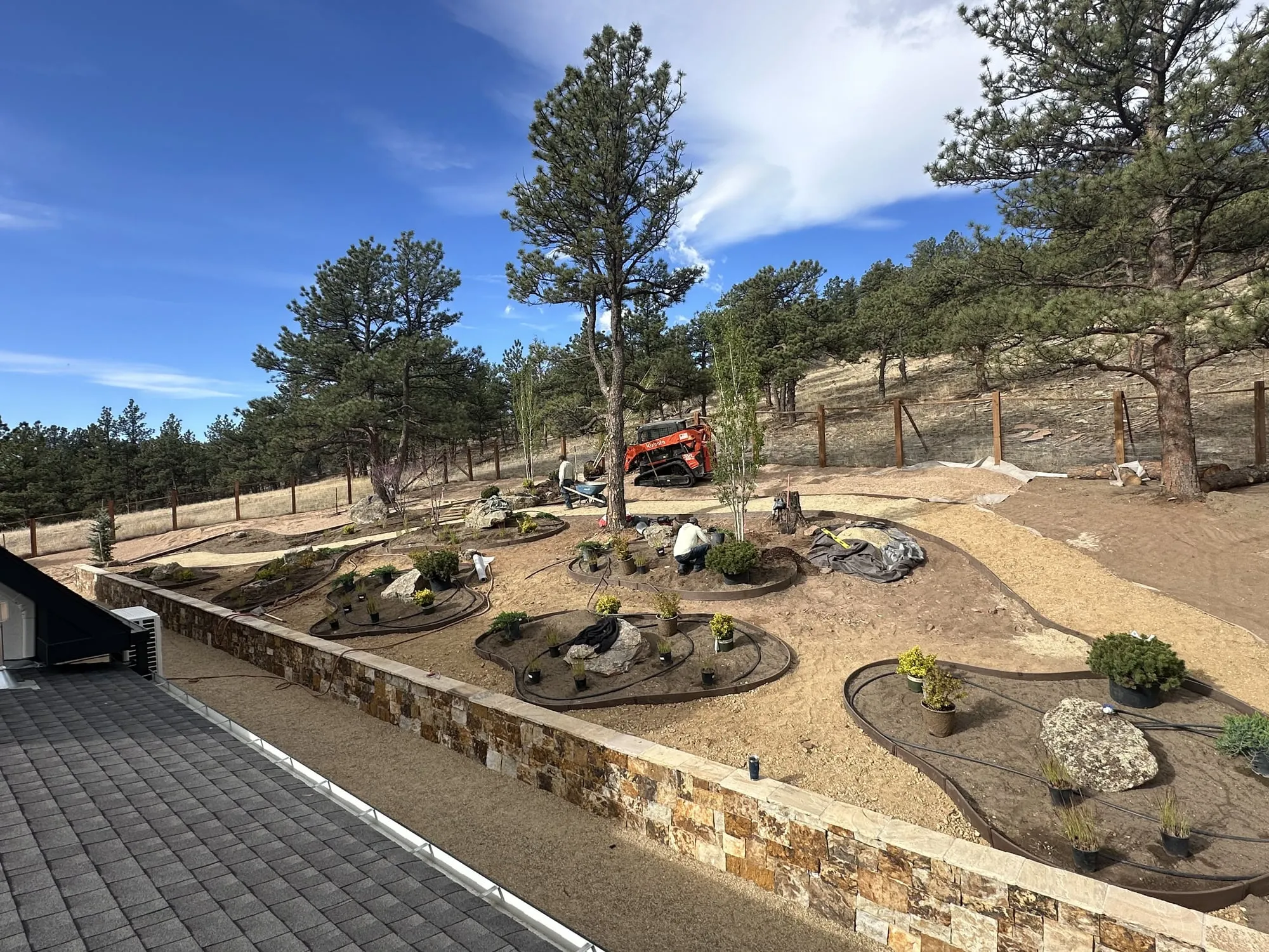 Wide xeriscape design with rock beds and boulders